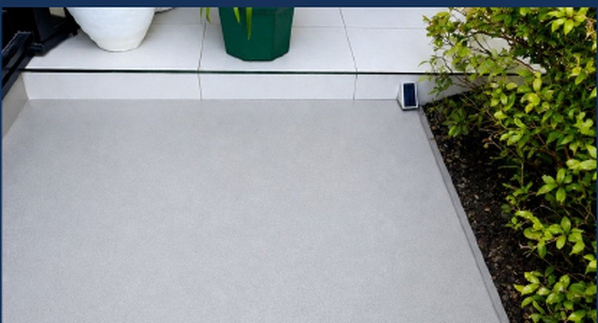 The same concrete patio after pressure washing